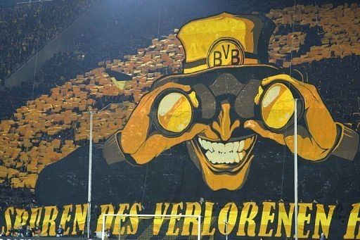 Dortmund's fans wave yellow colours behind a giant poster on April 9, 2013
